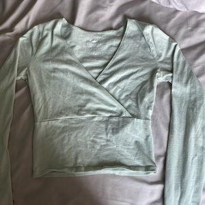 Hollister baby tee long sleeve that is a very light turquoise color.